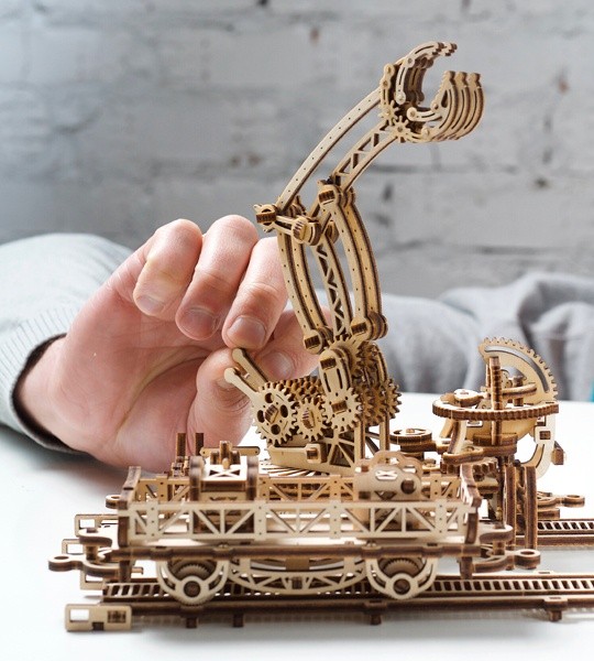 Ugears mechanical model kit Rail Mounted Manipulator and wooden 3D puzzle. Articulated claw on rotating platform with control levers, tracks, crane and characters. Original gift for boys and girls and smart hobby for grown-ups.